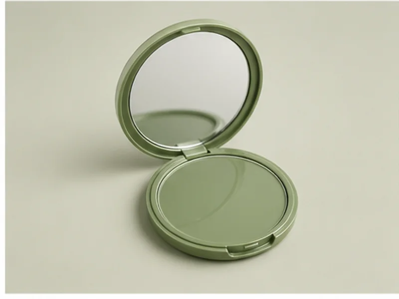 Realistic studio product photo of the pretend product Matcha Mirror Compact.