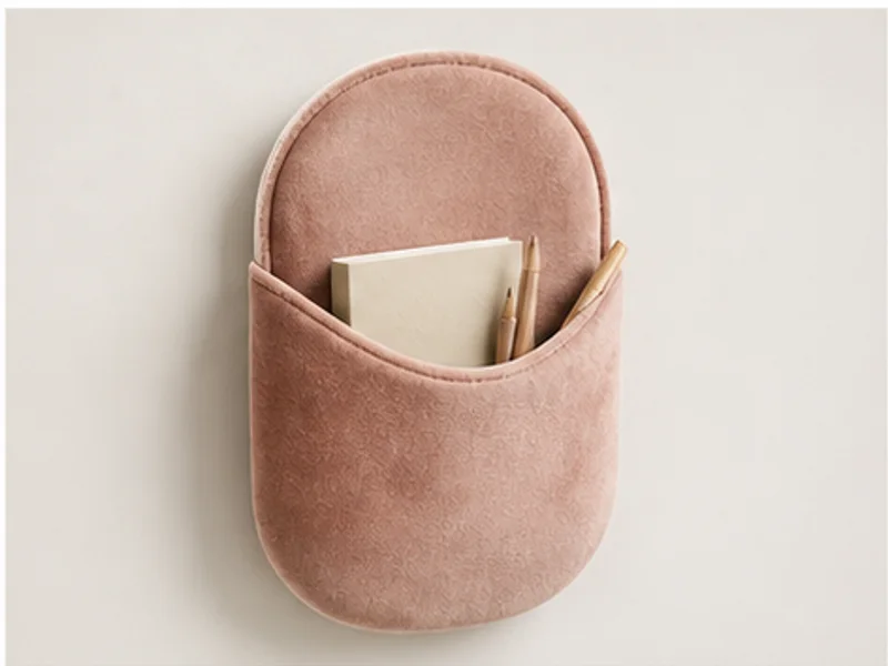 Realistic studio product photo of the pretend product Velvet Wall Pocket.